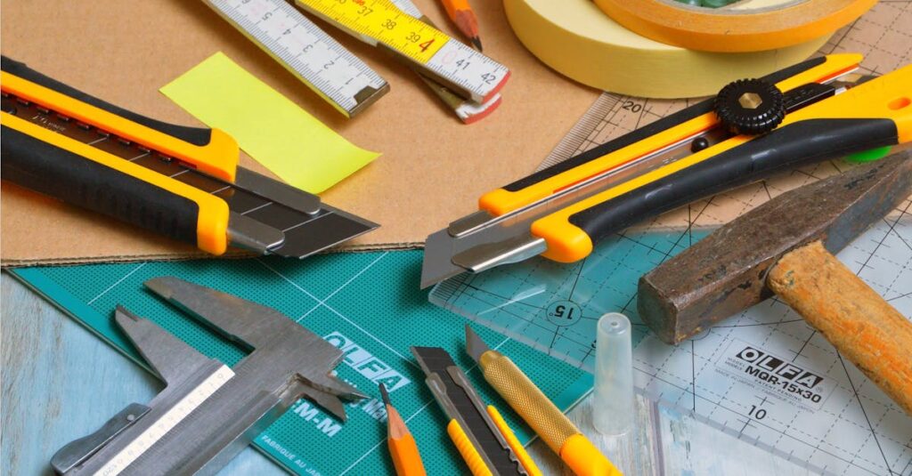 A variety of crafting tools including cutters, ruler, and tape on a work desk.